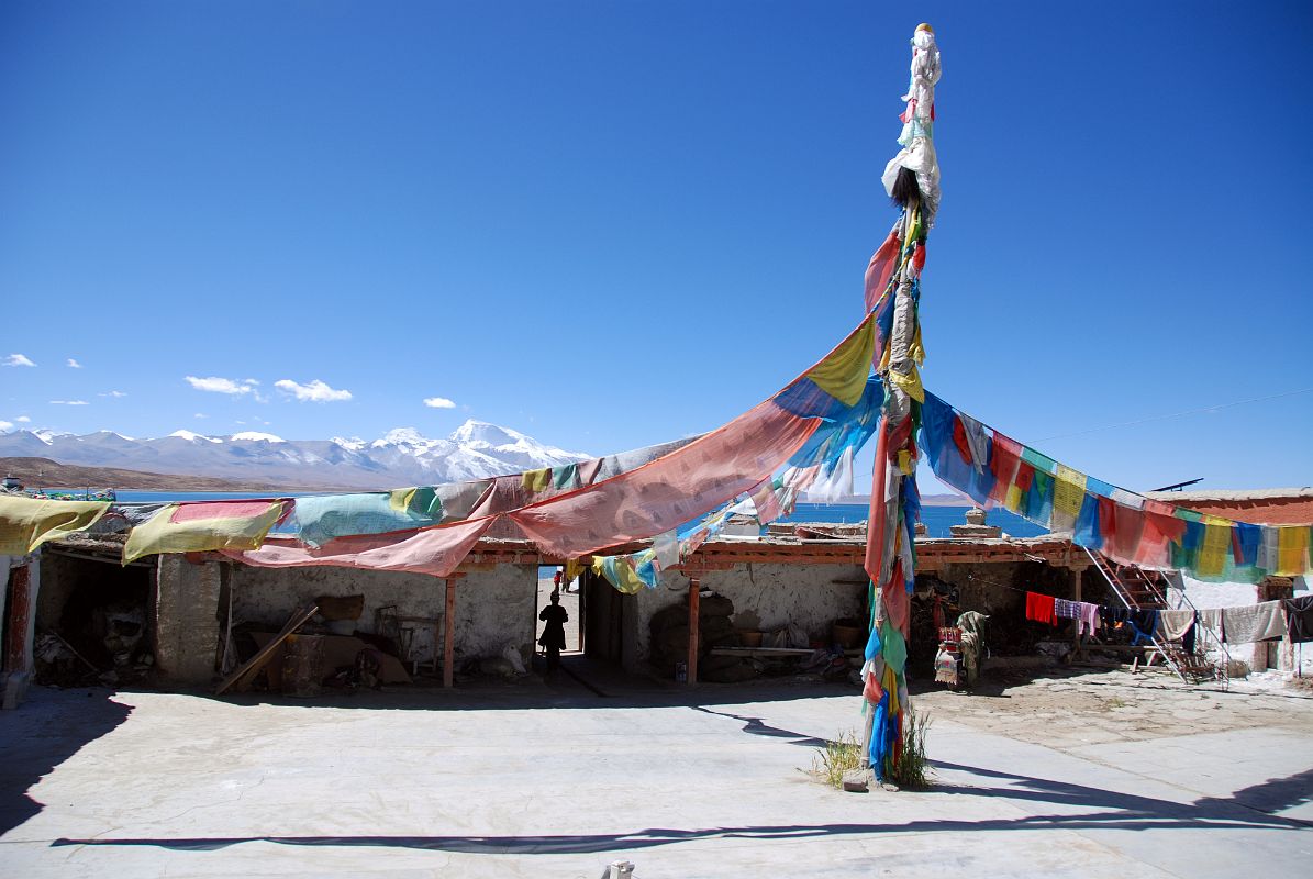 15 Seralung Gompa Courtyard Flagpole With Lake Manasarovar And Gurla Mandhata Beyond The courtyard of Seralung Gompa has a tall flagpole with a view to lake Manasarovar.